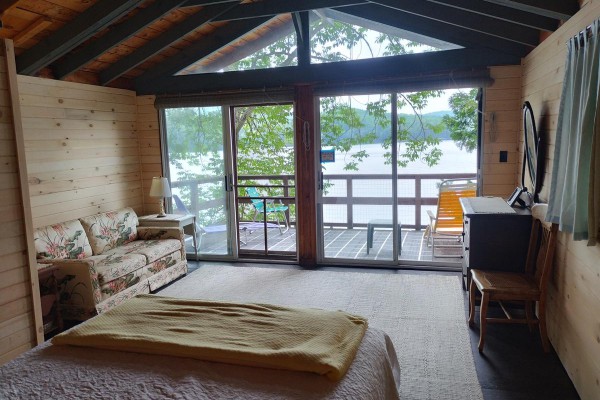 Chickadee Cottage bedroom and deck right on the lake