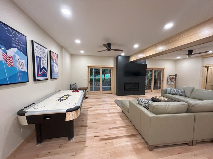 Rec room with leather sectional, fireplace, 65 Smart TV