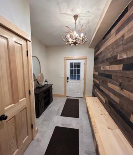 Warm, inviting, rustic foyer/entrance with 8 ft bench