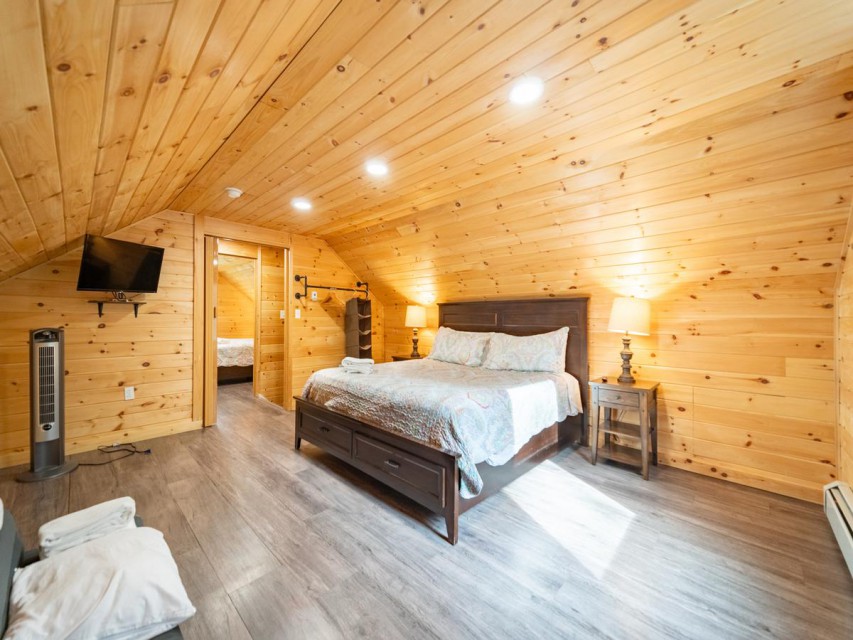 Upstairs bedroom with king sized bed and TV