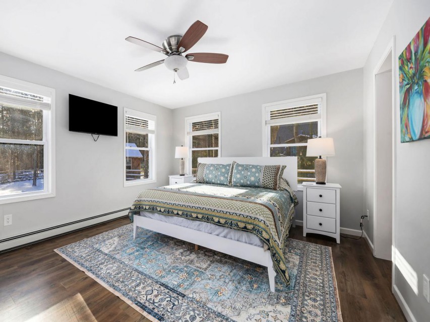 Ensuite bedroom features a king bed and mtn views.