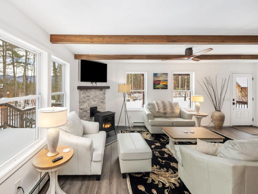 Custom wood beams has ample seating plus a Smart TV.