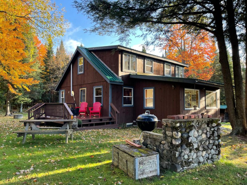 Cabin exterior, back deck and outdoor fireplace