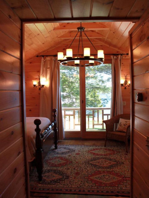 Lodge master bedroom with balcony facing lake