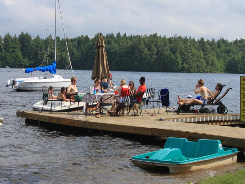 Lodge private dock with lounge chairs table & umbrella