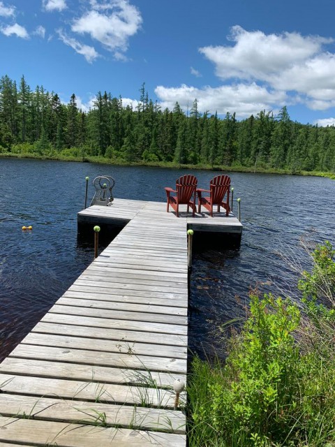 The floating dock has ADK chairs and a swim ladder. 