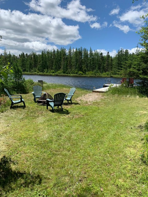 By the pond:  A fire pit with seating