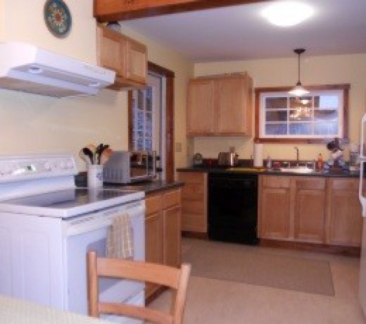 The dining area adjoins a full kitchen.