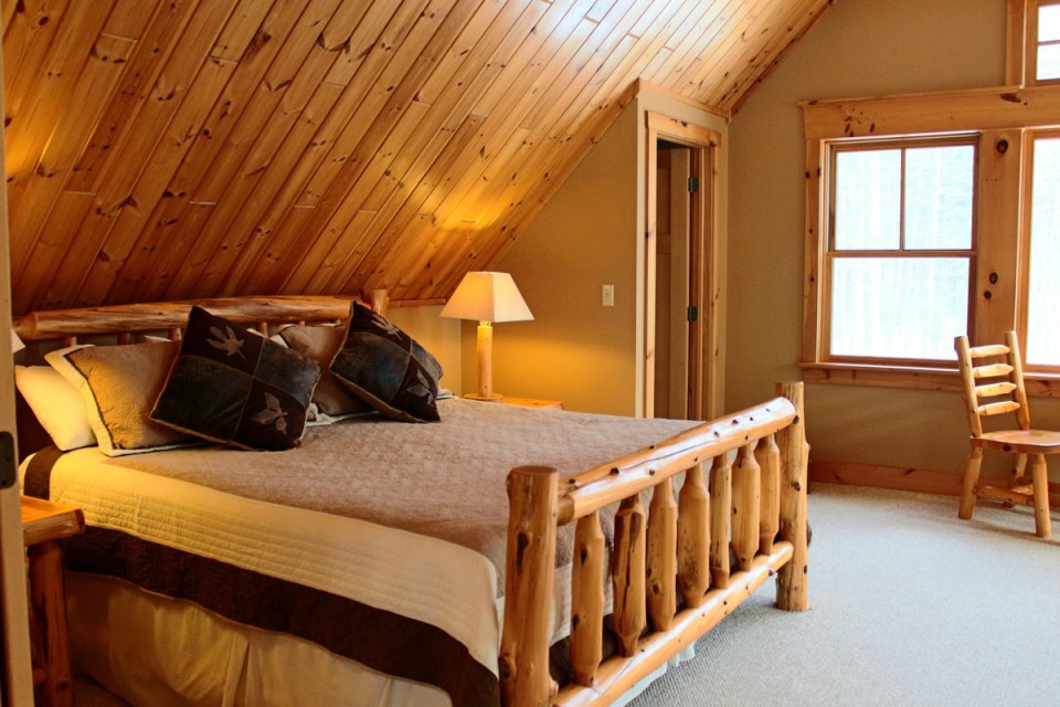 master suite with king size bed and log furnishing